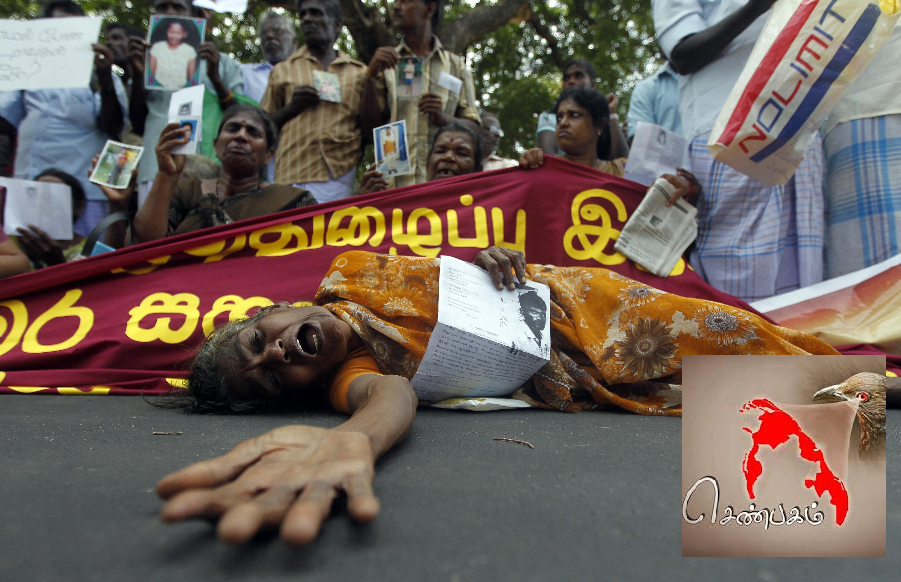 Tamil woman cries as she holds up an image of her disappeared family member during the war against Liberation Tigers of Tamil Eelam at a protest in Jaffna